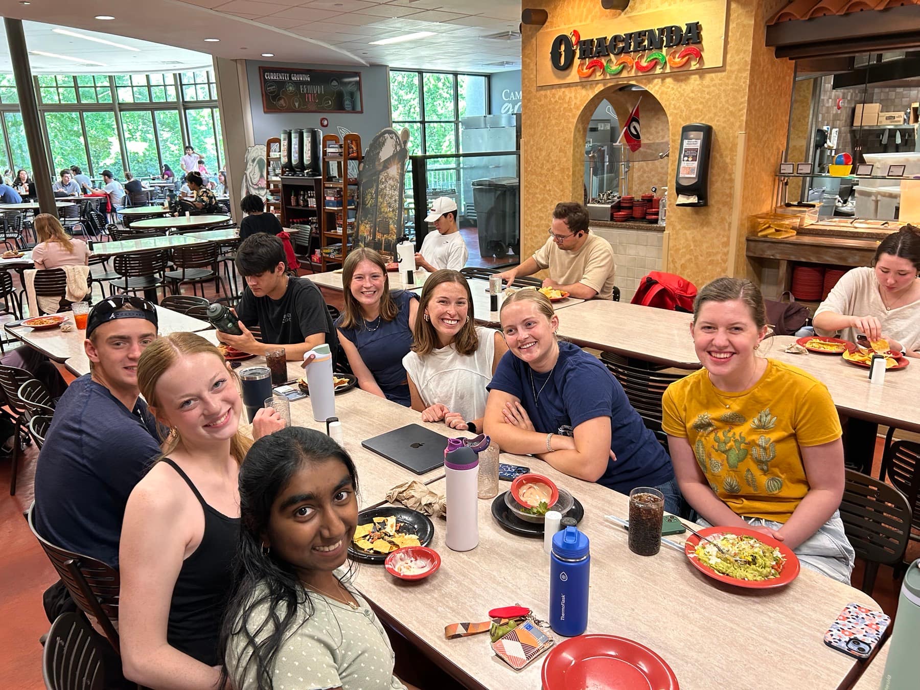Freshman students gathered around a dining hall table