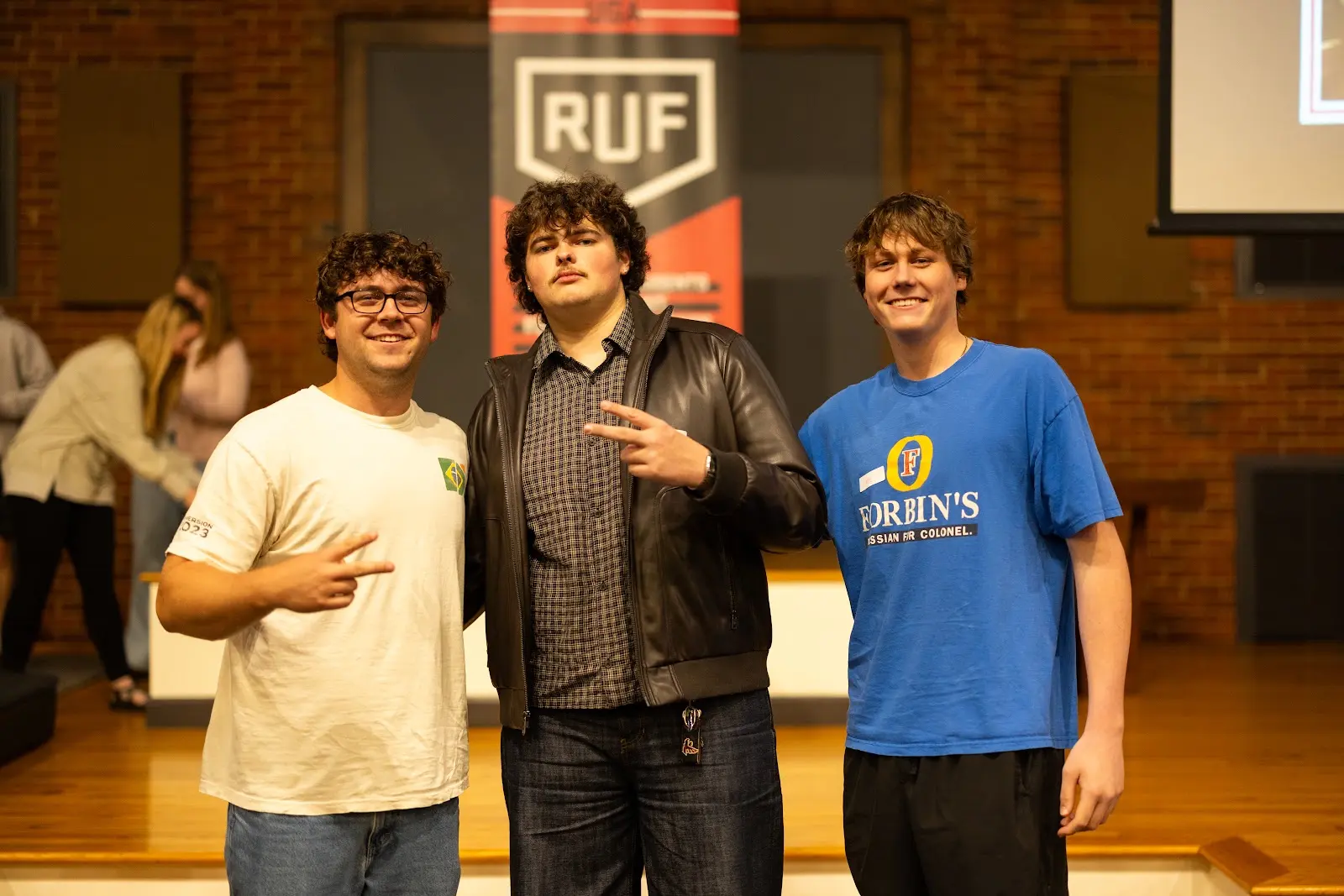 Three RUF at UGA friends smiling together after Large Group