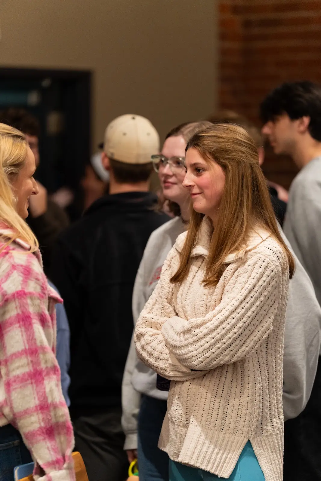 A student talking with friends in the Large Group room
