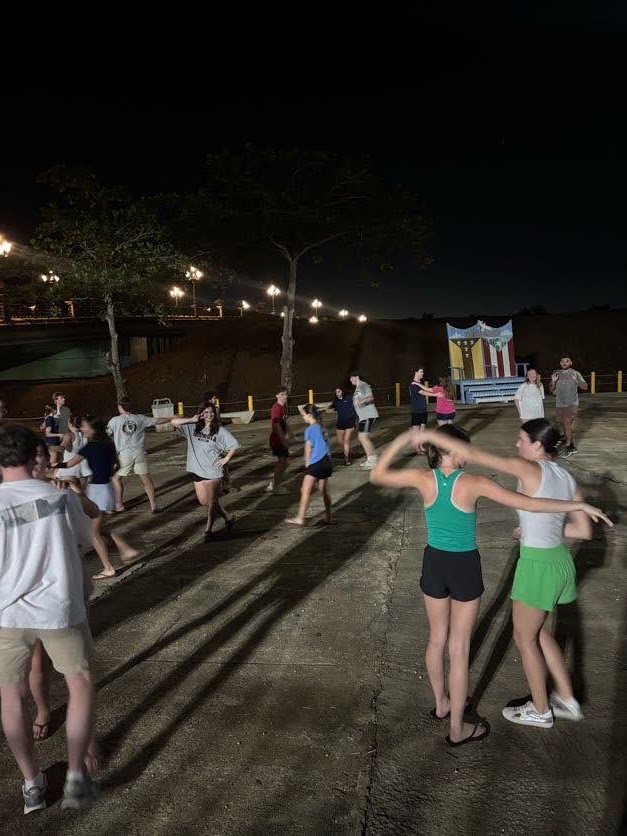Friends dancing together during an evening gathering