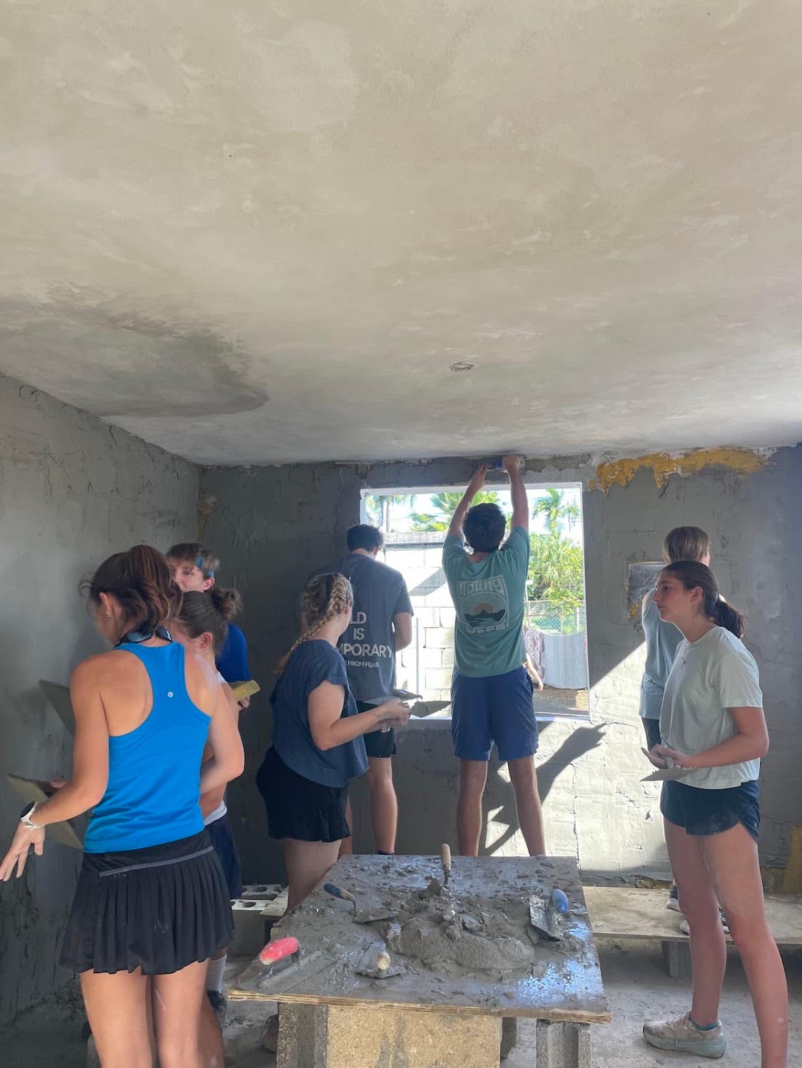 A large group of students completing an indoor service project