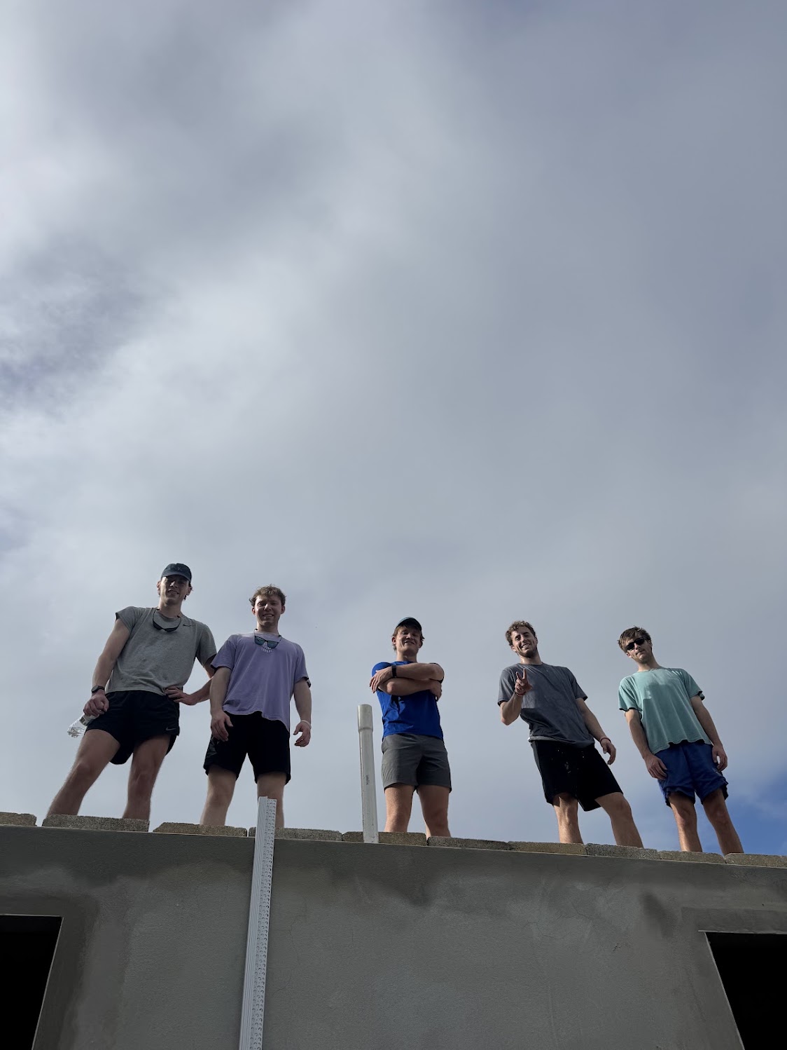 Teammates serving together on the roof of a community building