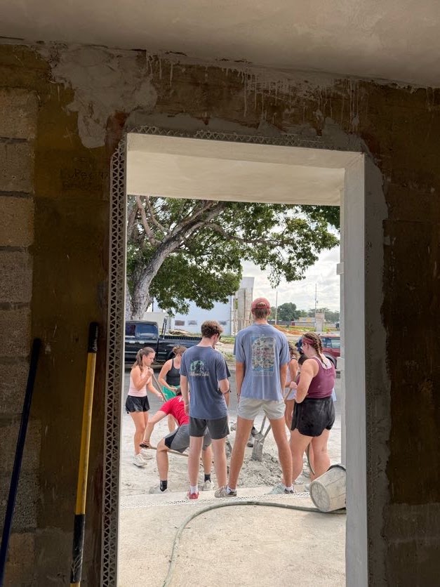 Students coordinating work across an open doorway