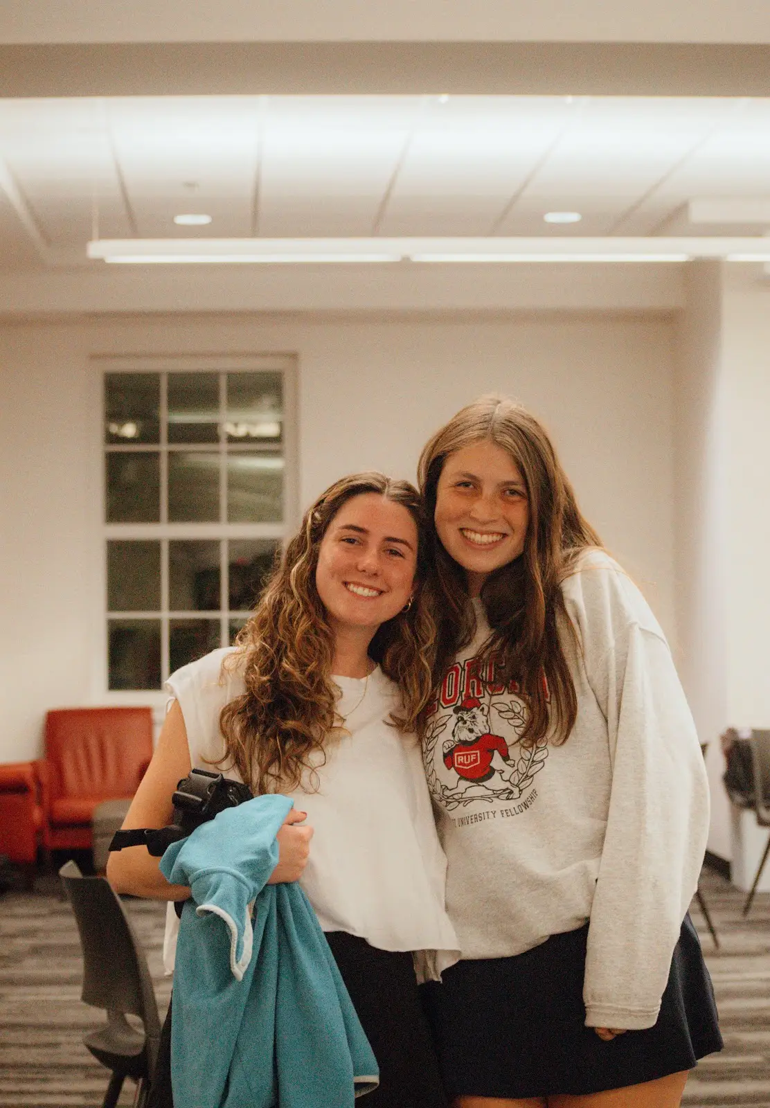 Two friends smiling together at Freshmen Fellowship