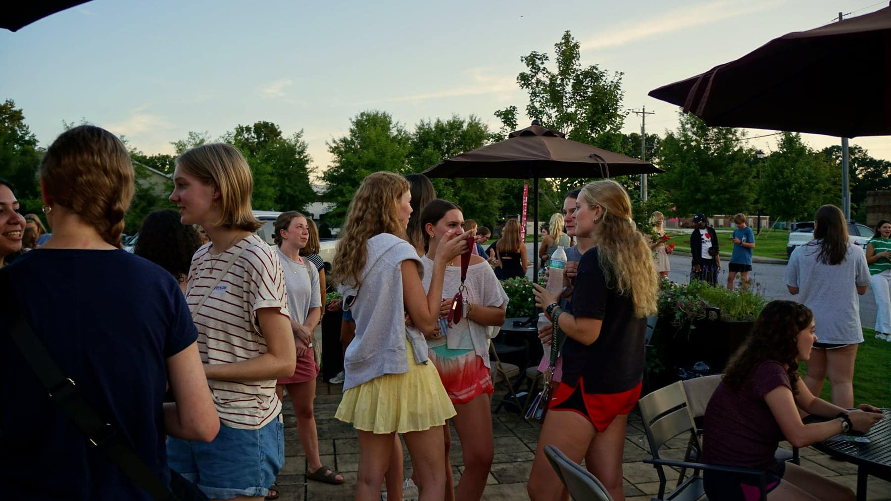 Students laughing together outside during Trivia Night