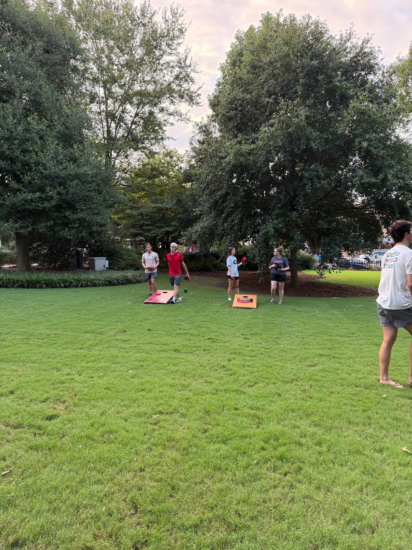 Students meeting one another beneath the trees during Welcome Week lawn games